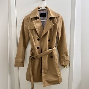 Tan colored belted trench coat